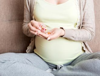 pregnant-woman-with-pills-hand-healthcare-concept-medicine-pregnancy_1048944-8847414